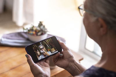 Senior woman using smart phone at home