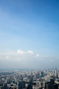 High angle view of buildings against blue sky