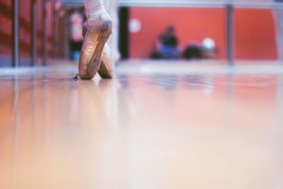Low section of ballet dancer on floor