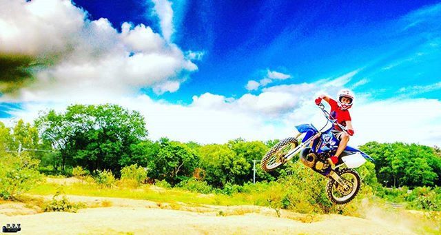 bicycle, transportation, sky, land vehicle, mode of transport, cloud - sky, tree, blue, landscape, grass, riding, cloud, field, day, nature, tranquility, green color, stationary, scenics