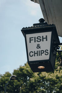 Low angle view of information sign against sky