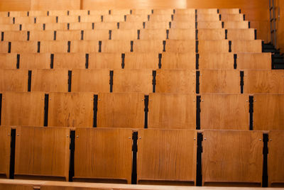 Empty wooden seats in auditorium