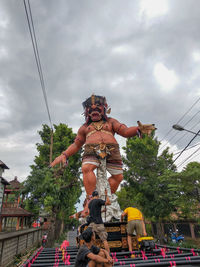 Low angle view of statue against sky