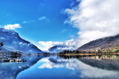 Scenic view of lake and mountains against sky