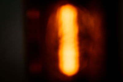 Defocused image of fire against dark background