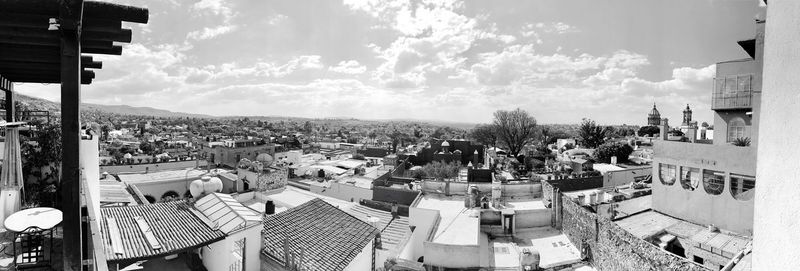 High angle view of houses in town against sky