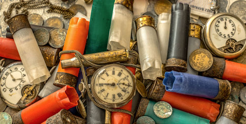 Full frame shot of old pocket watches and cartridges