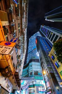 Low angle view of modern buildings in city at night