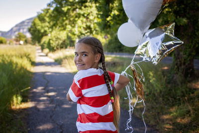 Portrait of cute girl blowing bubbles
