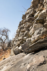 Low angle view of rock formation against clear sky