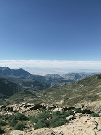 Scenic view of mountains against clear blue sky