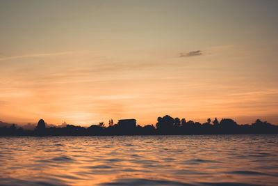Scenic view of sea against romantic sky at sunset