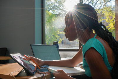 Young woman using laptop at table