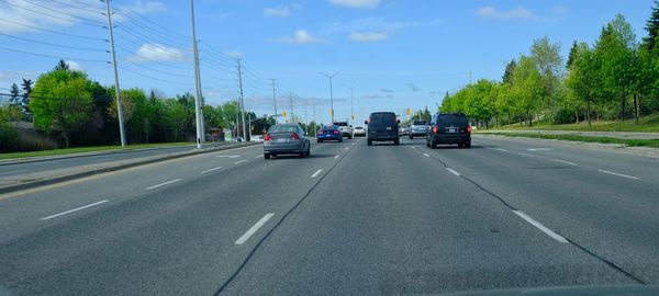 Cars on road against sky