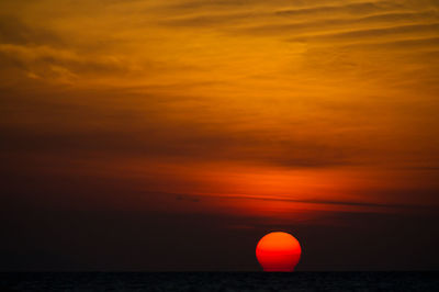 Scenic view of sea against orange sky