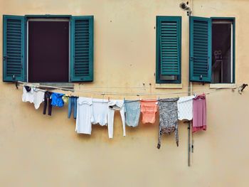 Clothes drying on clothesline against building