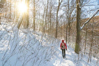 Full length of woman walking on snow covered land