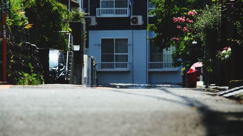 Empty road by buildings in city