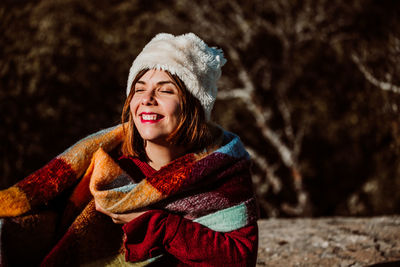 Portrait of a smiling young woman in snow