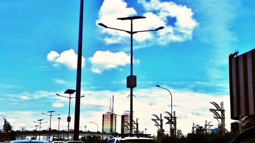 Low angle view of street light against cloudy sky