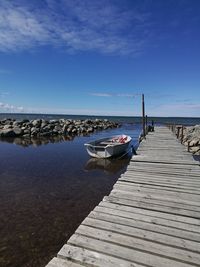 Pier over sea against blue sky