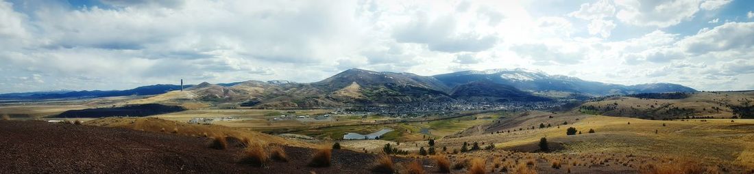 Scenic view of mountains against cloudy sky