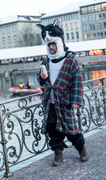 Portrait of man holding camera in city