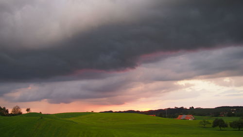 Countryside landscape against cloudy sky