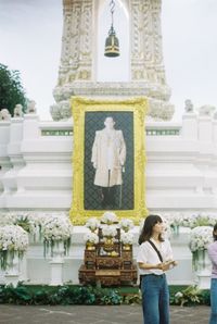 Statue of woman against temple