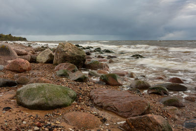 Rocks on beach against sky