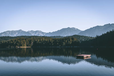 Scenic view of lake and mountains against clear sky