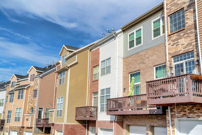 Low angle view of buildings in town against sky