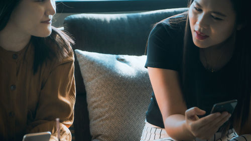 Midsection of woman using mobile phone