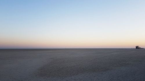 Scenic view of sea against clear sky during sunset