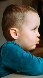 Close-up of boy looking away at home