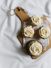 High angle view of white roses on table