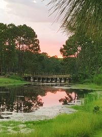 Scenic view of lake against sky at sunset
