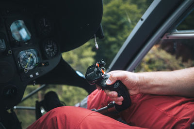 Pilot helicopter emergency medical service during flight. close-up of flight control inside cockpit.