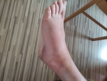 Low section of person legs on wood