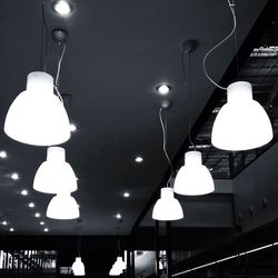 Low angle view of electric lamp hanging on ceiling