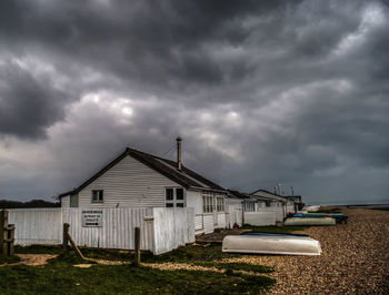 Houses against cloudy sky