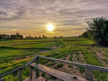 Scenic view of field against sky during sunset