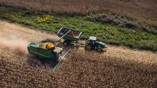 Combine harvester loading corn into a hauler wagon in kentucky 