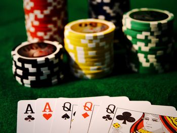 Close-up of cards and gambling chips on table