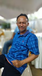 Portrait of smiling man sitting outdoors