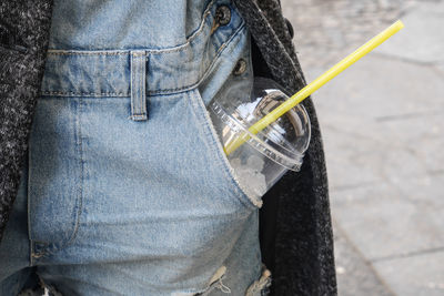 Close-up mid section of a woman with drink