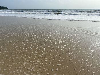 Surface level of beach against sky