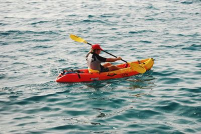 Rear view of man on boat in sea