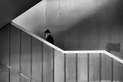 Side view of man walking on steps in building
