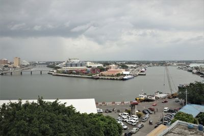 High angle view of buildings by sea against sky